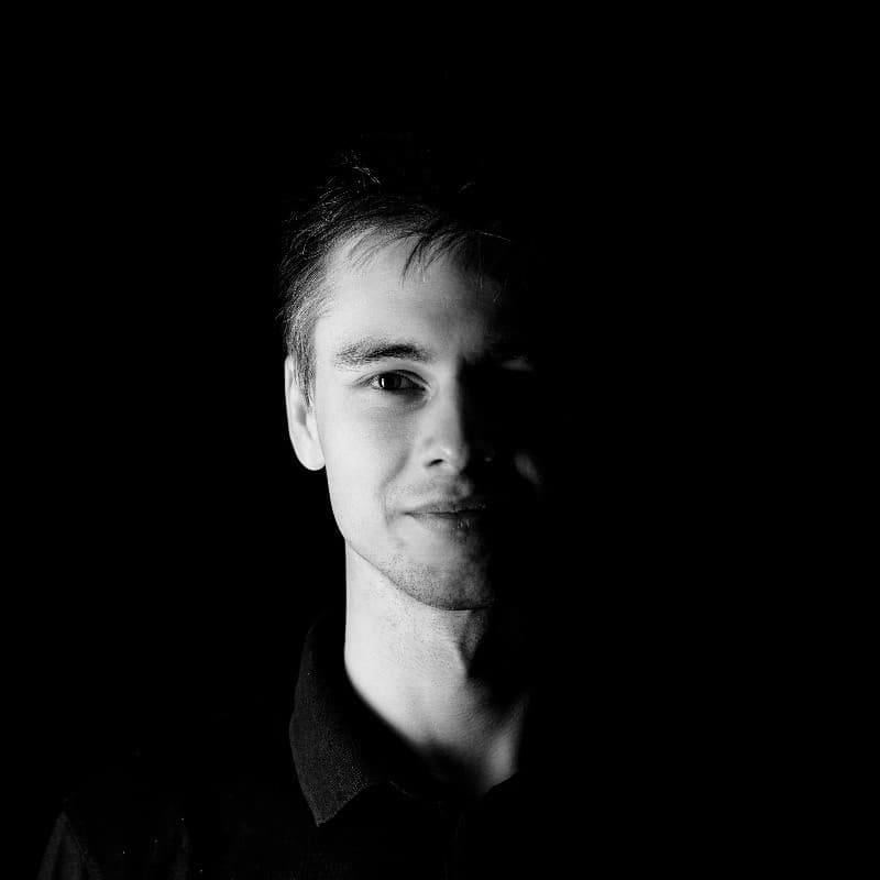 A professional headshot of Marcin Witecki